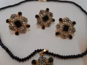 Black Flower shaped golden pendant set with matching pearls